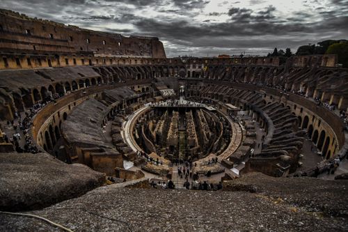 Free A breathtaking view of the ancient Colosseum surrounded by stormy clouds in Rome, Italy. Stock Photo