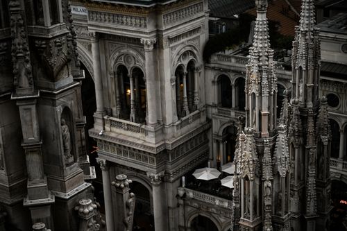 Free Intricate Gothic architecture detail of Milan Cathedral rooftop spires and sculptures. Stock Photo
