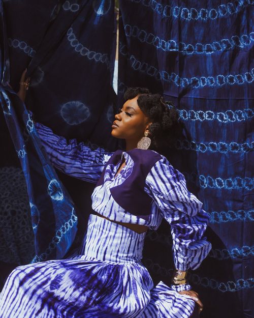 Free Woman in vibrant blue Nigerian attire showcasing traditional tie-dye patterns, exuding elegance and cultural richness. Stock Photo