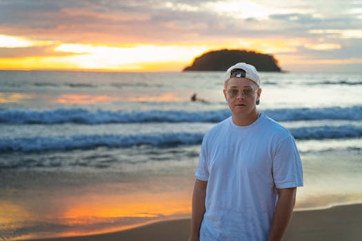 Adult male on Phuket beach at sunset, capturing serene tropical vibes.