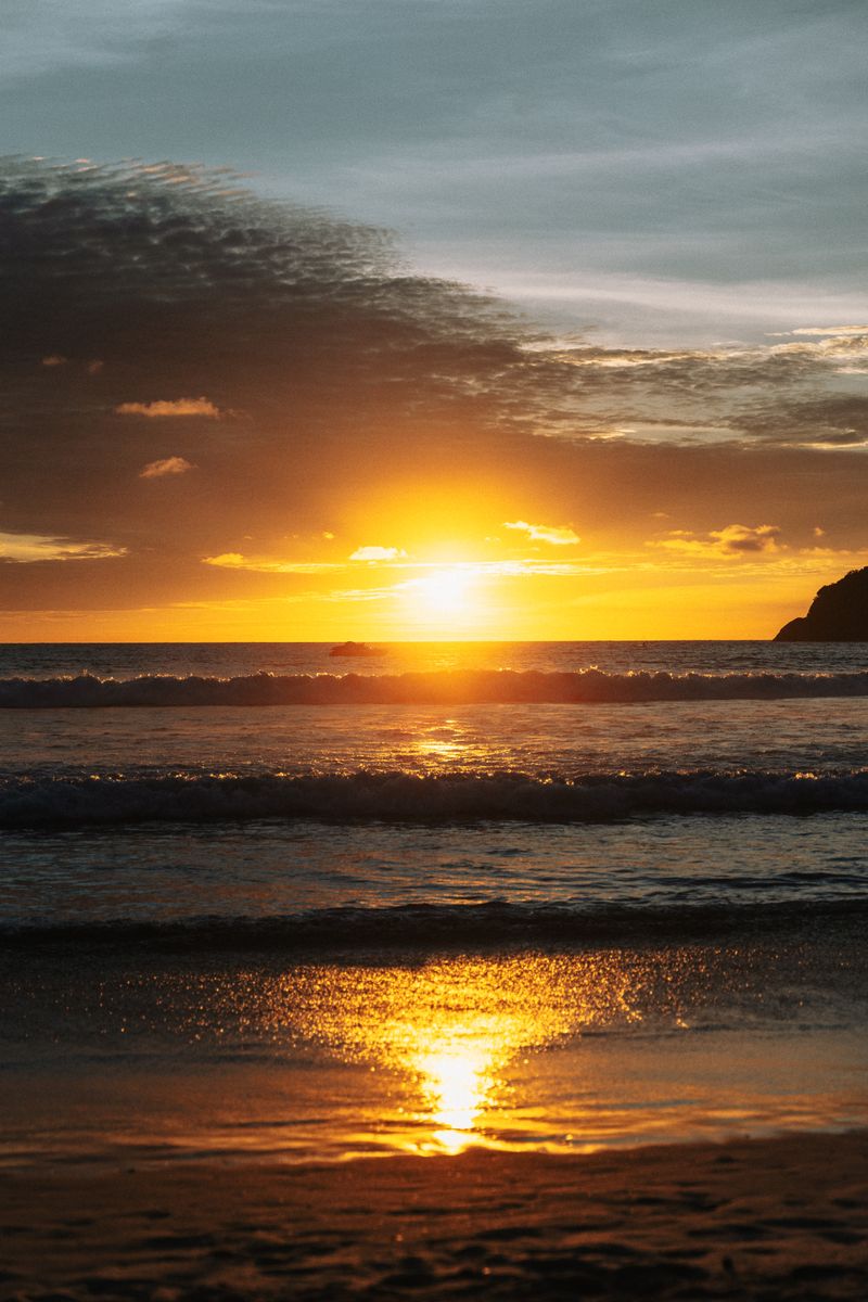 Golden sunset breaking over the sea at Kata Beach, Phuket