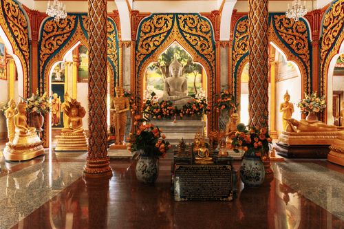 Free Lavishly decorated temple interior showcasing golden Buddha statues and intricate designs in Phuket, Thailand. Stock Photo