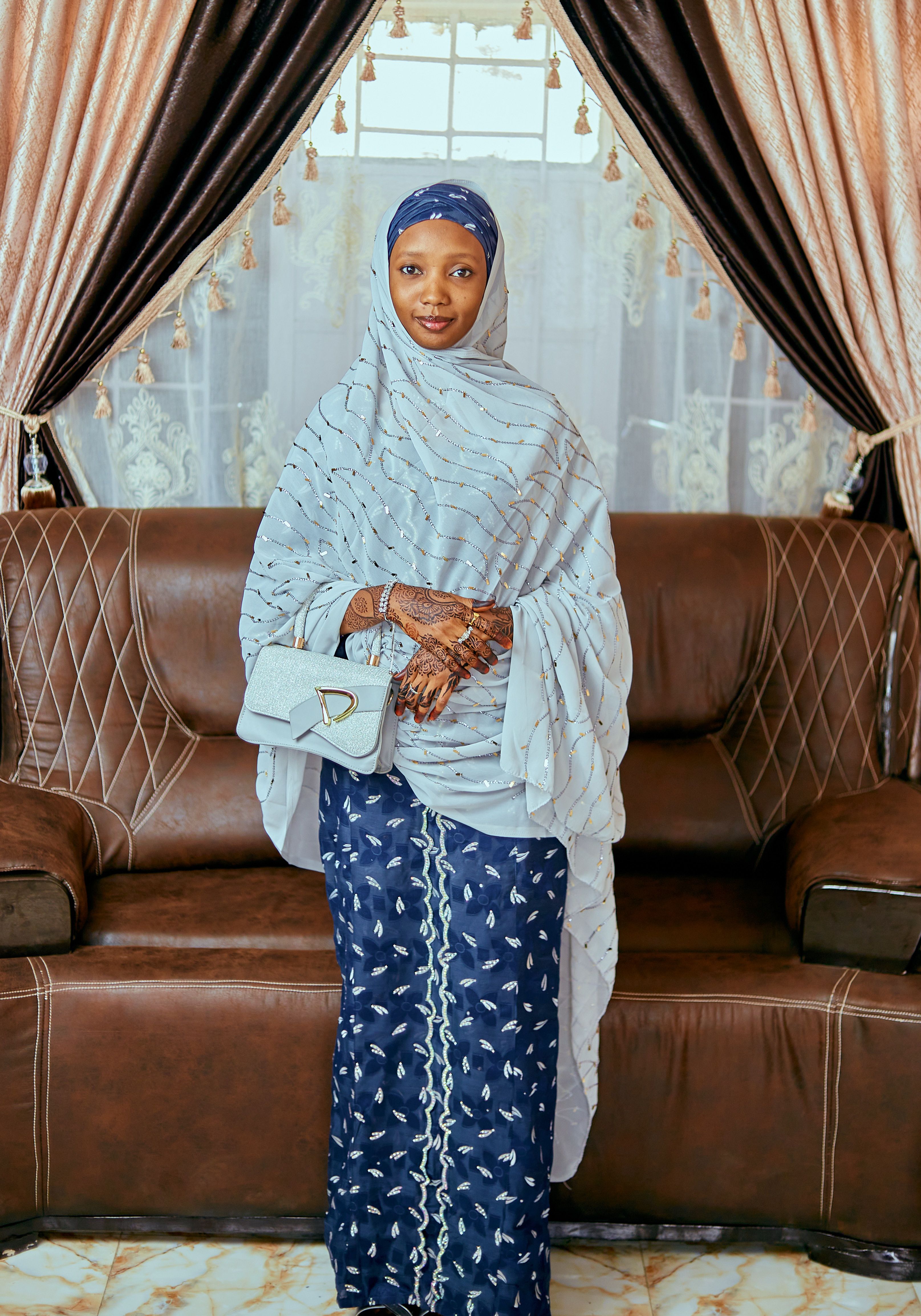 Elegant Woman in Traditional Attire on Sofa · Free Stock Photo