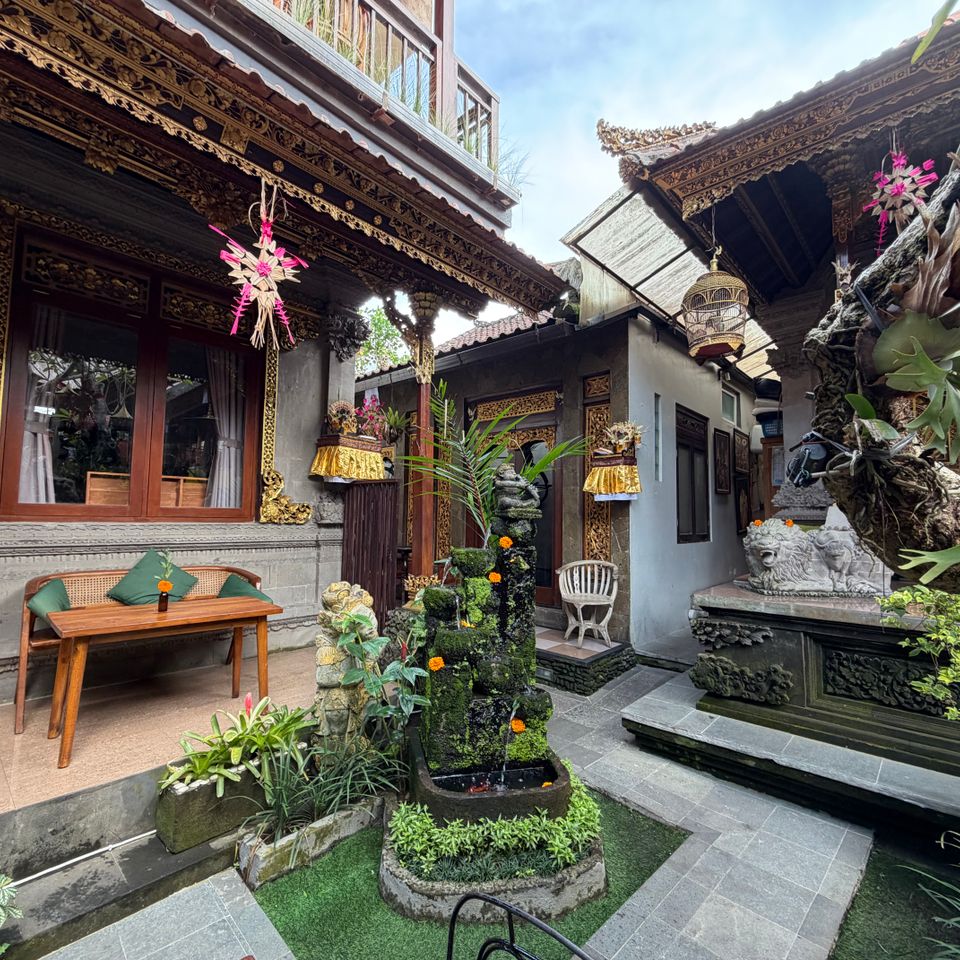 Balinese courtyard with carved stone details and tropical plants
