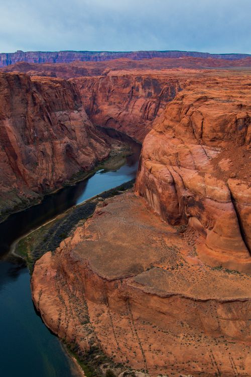Free Stunning aerial view of Horseshoe Bend with dramatic red cliffs and winding Colorado River. Stock Photo