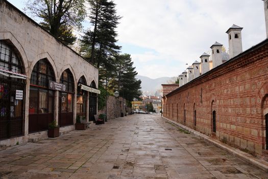 Explore the historic Ottoman architecture along a quiet street in Bursa, Turkey.