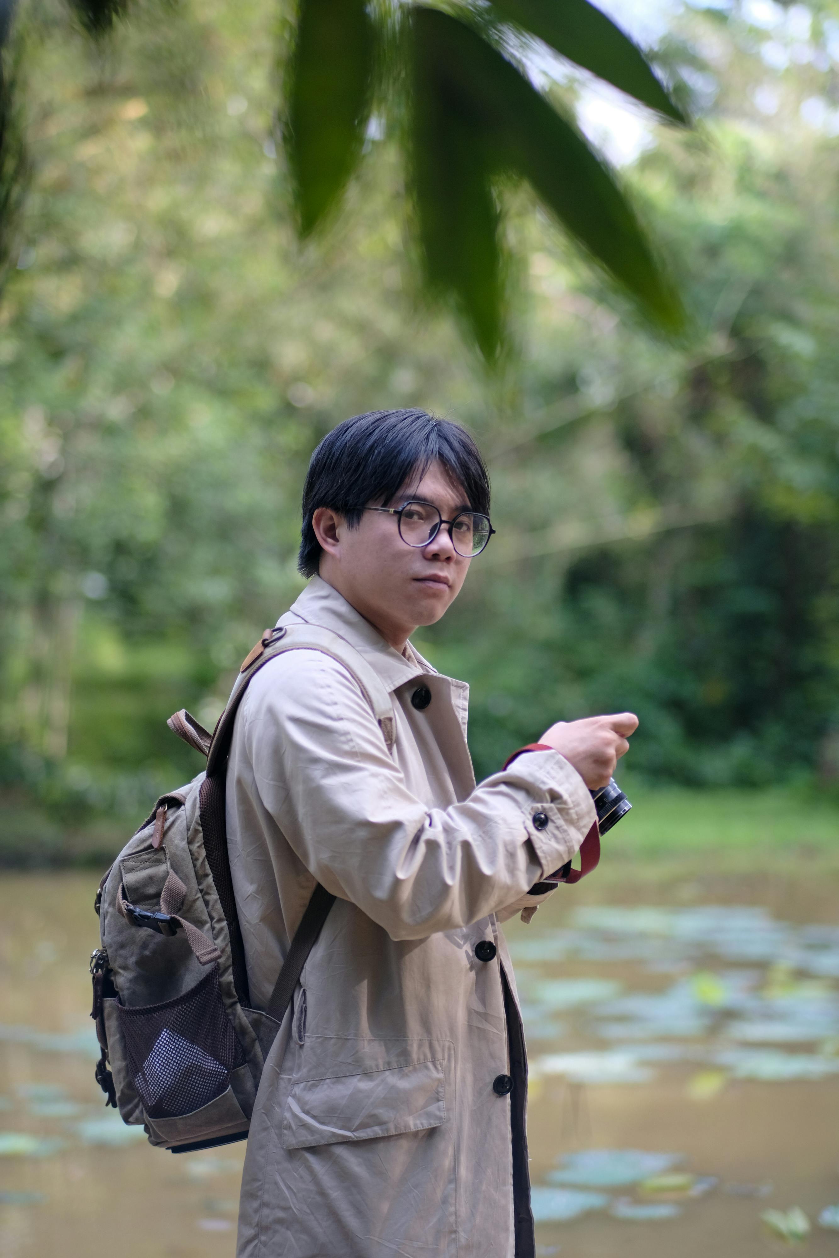 Portrait of a traveler in Hue City, Vietnam, amidst lush greenery.