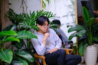 Contemplative Portrait in Lush Green Setting