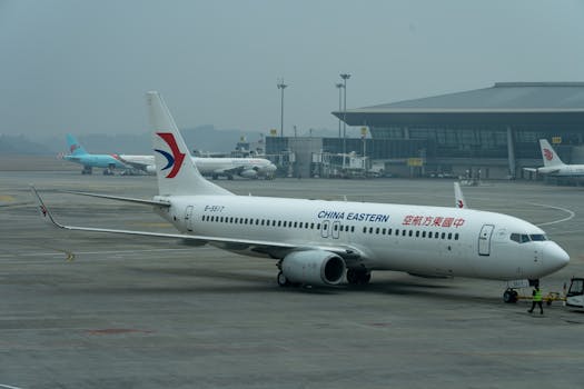 China Eastern Airlines Boeing 737 parked at the airport terminal, ready for boarding.