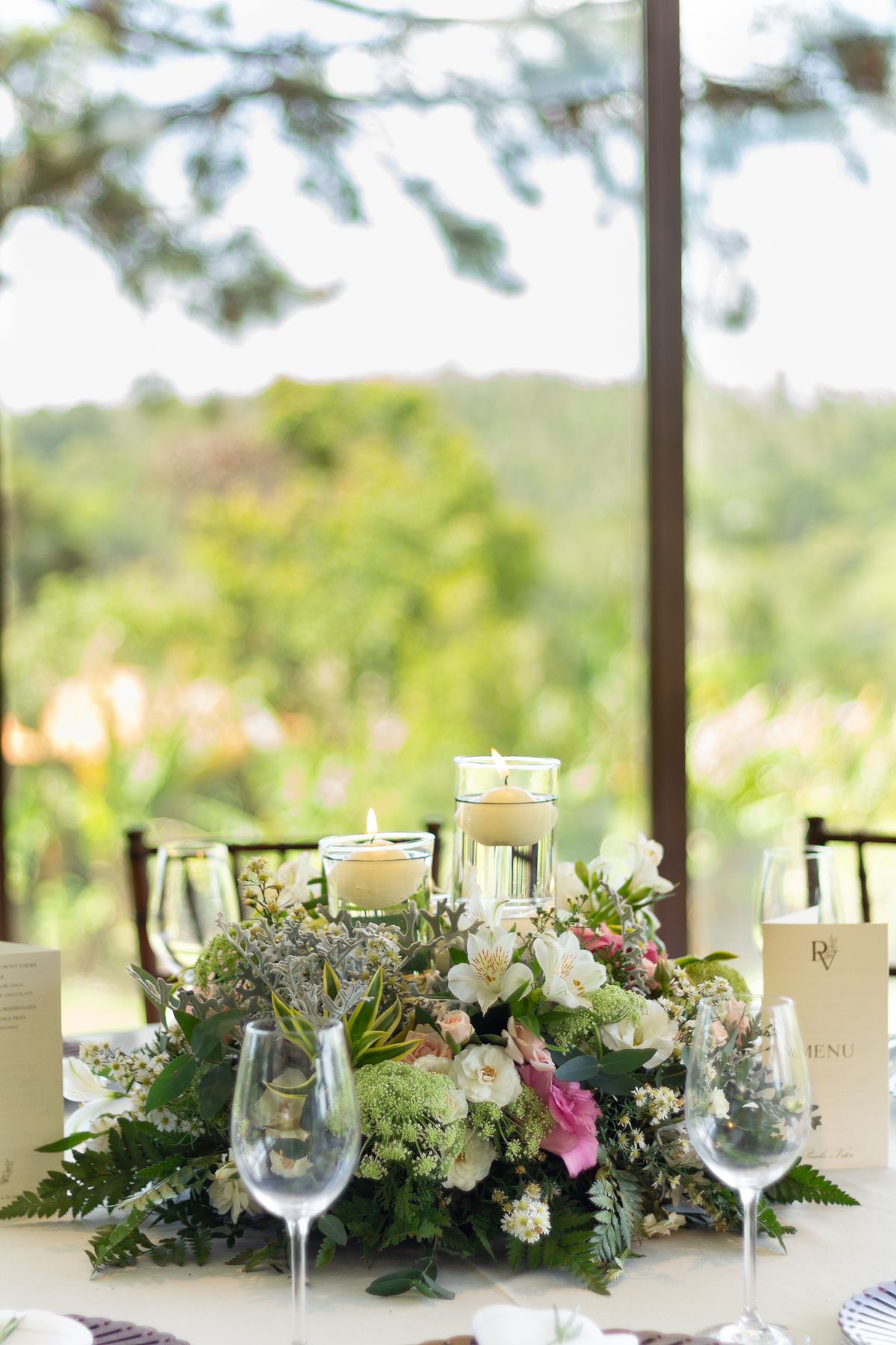 A candlelit wedding table dressed with garden flowers