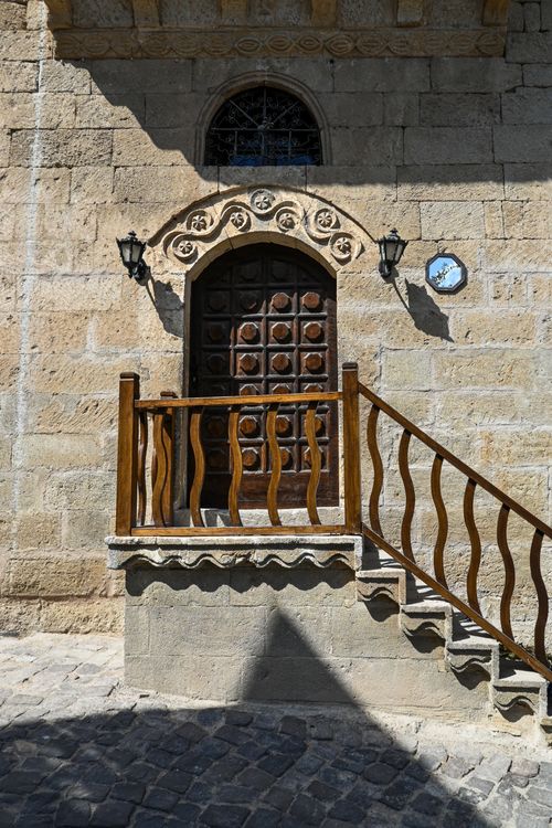 Free Historic stone building entrance featuring ornate wooden door and distinctive architecture. Stock Photo