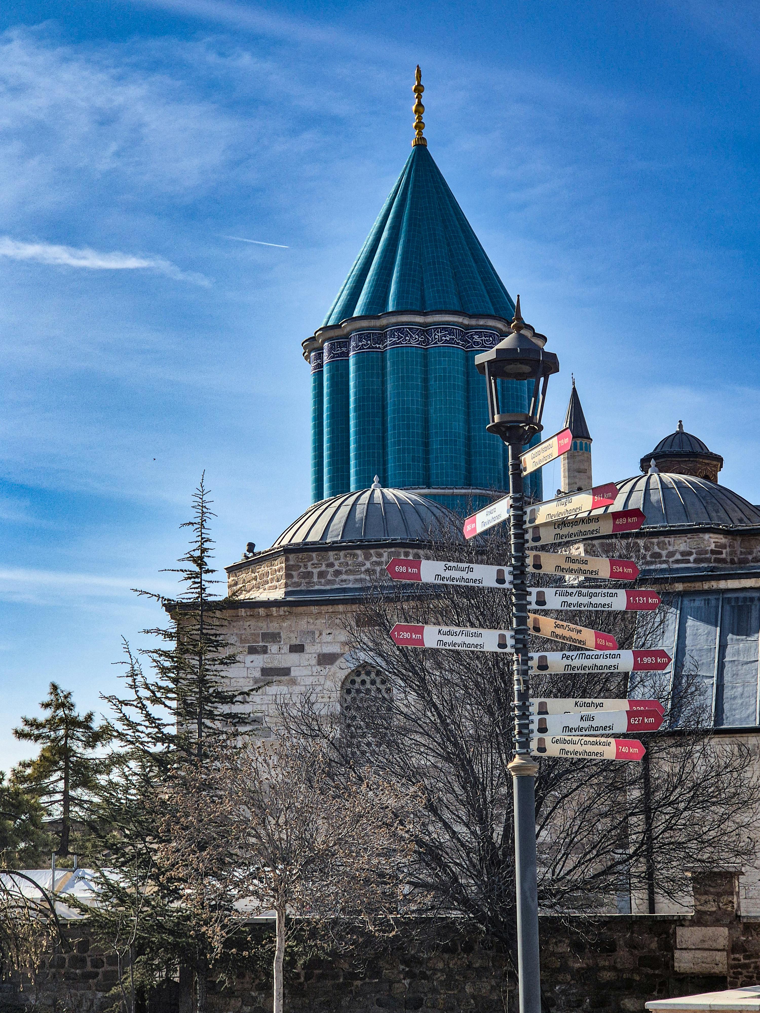 The iconic turquoise dome of Mevlana Museum in Konya, Turkey under a clear blue sky.
