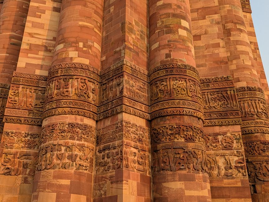 Detailed view of ornate sandstone carvings on Qutub Minar in New Delhi, India.