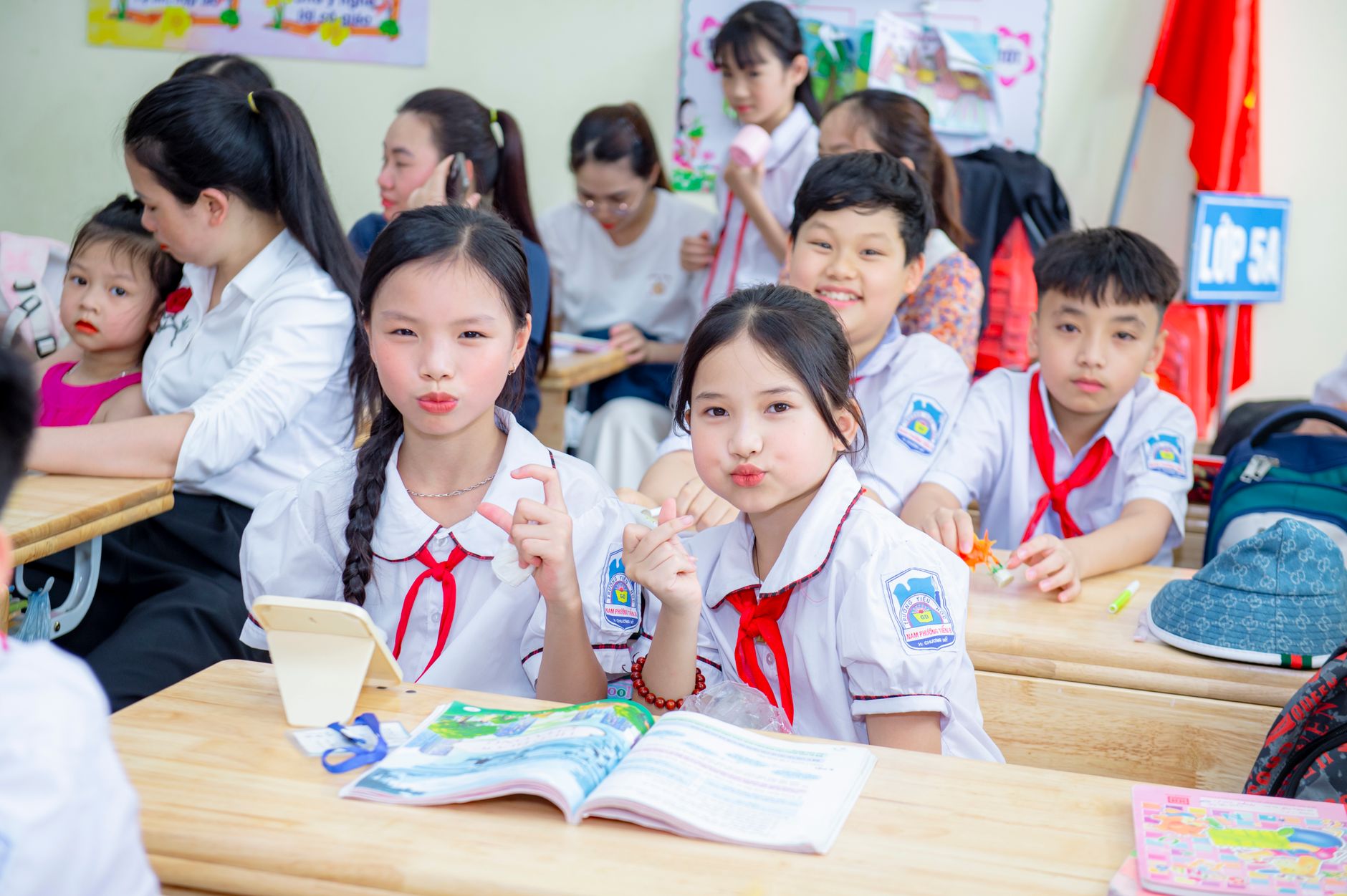 A lively classroom scene in Hanoi, Vietnam featuring students in uniform studying and interacting.