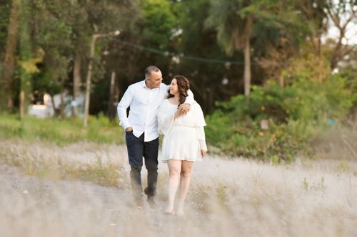 Free A couple strolling together outdoors in a peaceful garden setting, enjoying a calm moment. Stock Photo