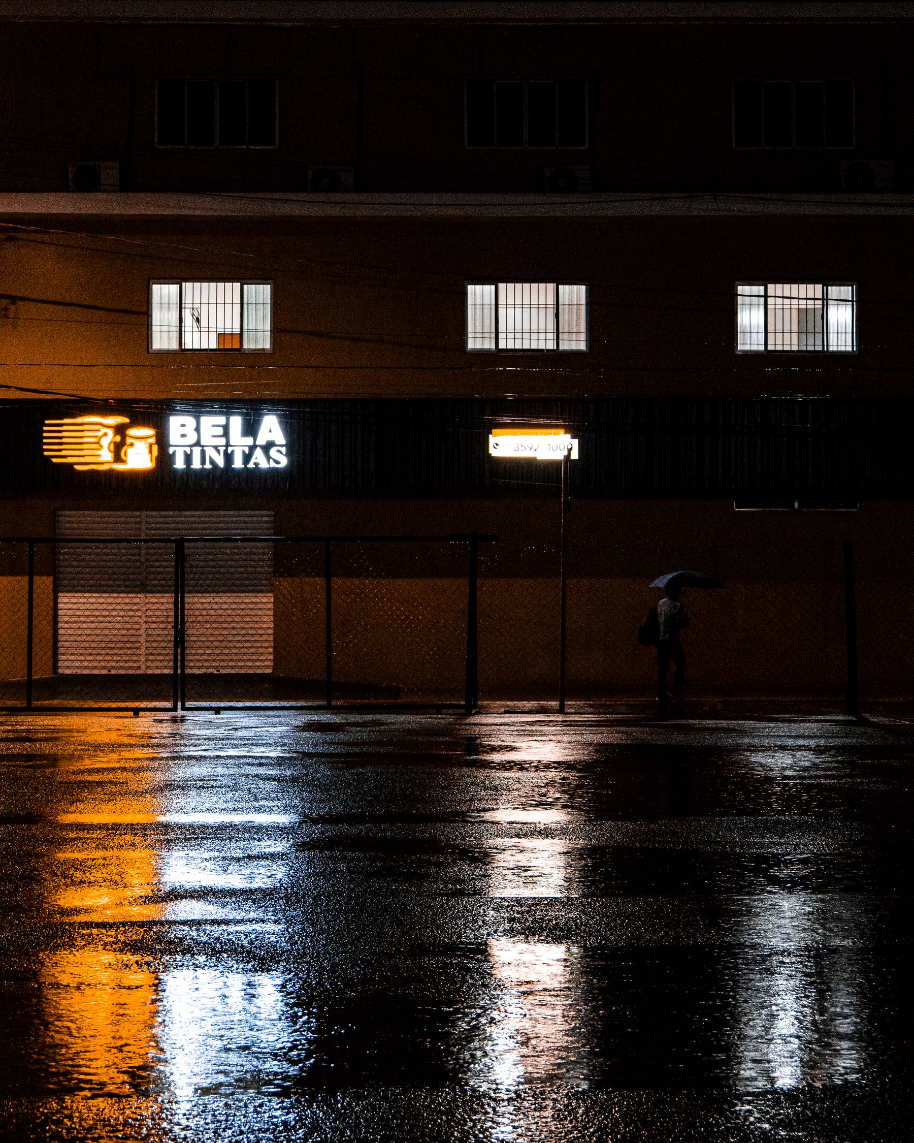 Neon light reflecting on a wet London street at night