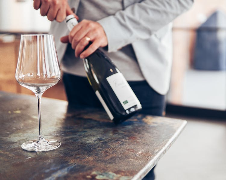 Photo Of Man Holding Wine Bottle