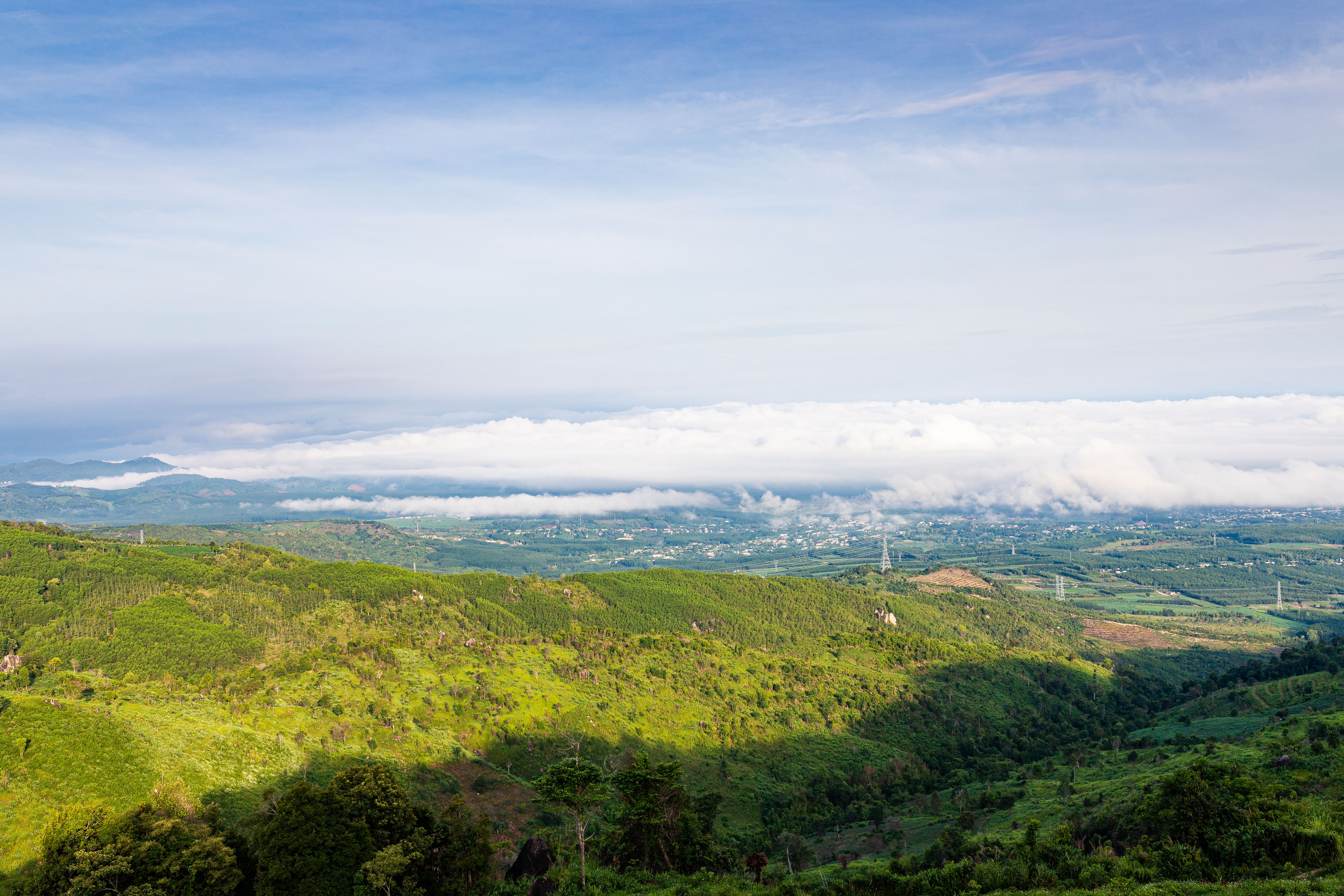 A breathtaking view of green hills and clouds in Kon Tum, Vietnam, showcasing natural beauty.