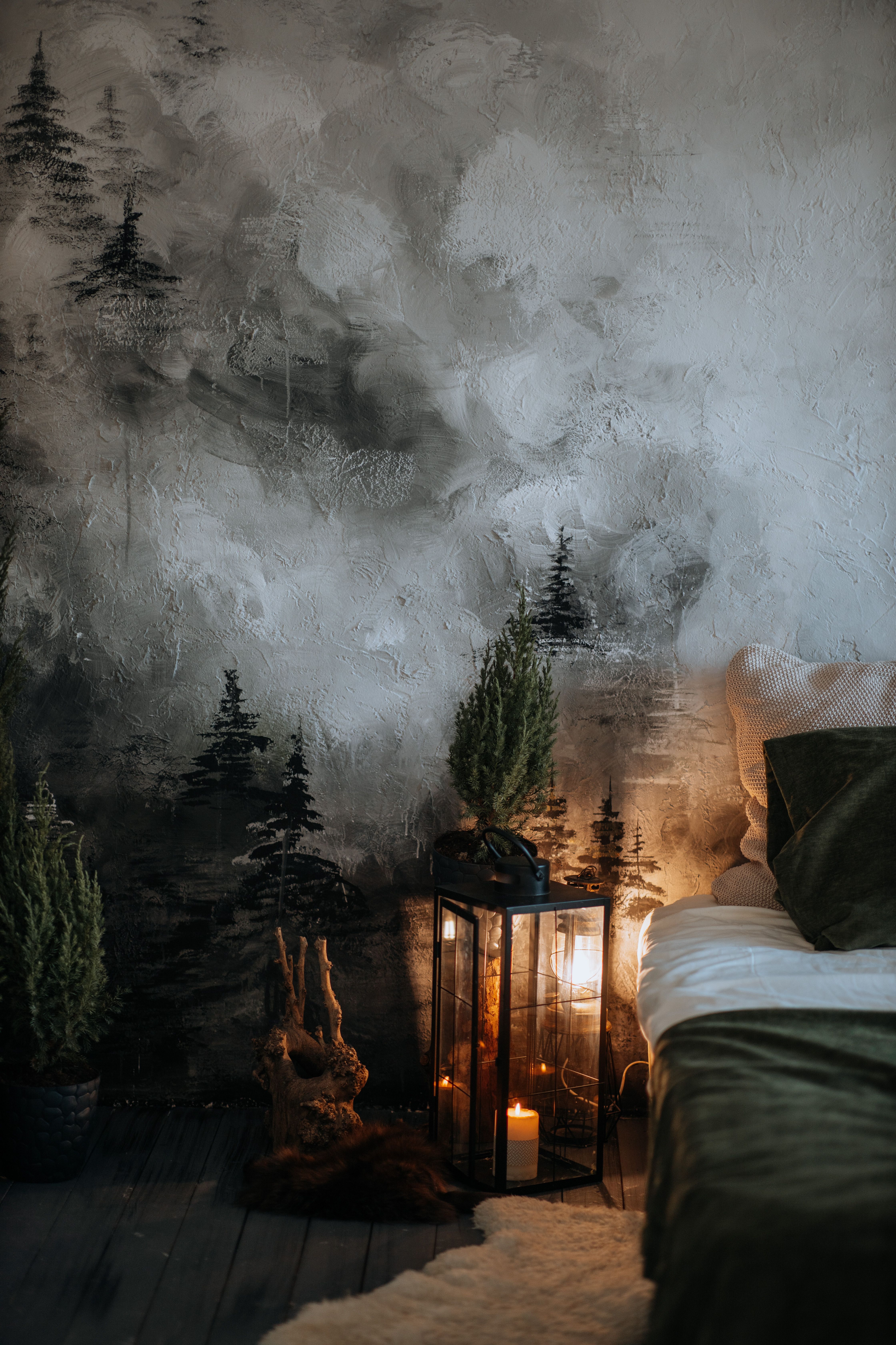 Fotomural Escena de dormitorio atmosférica con luz de velas y decoración artística en las paredes para una ambientación acogedora de invierno.