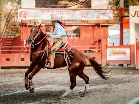 A young charro skillfully rides a horse during a Mexican rodeo event, showcasing traditional attire and horsemanship.