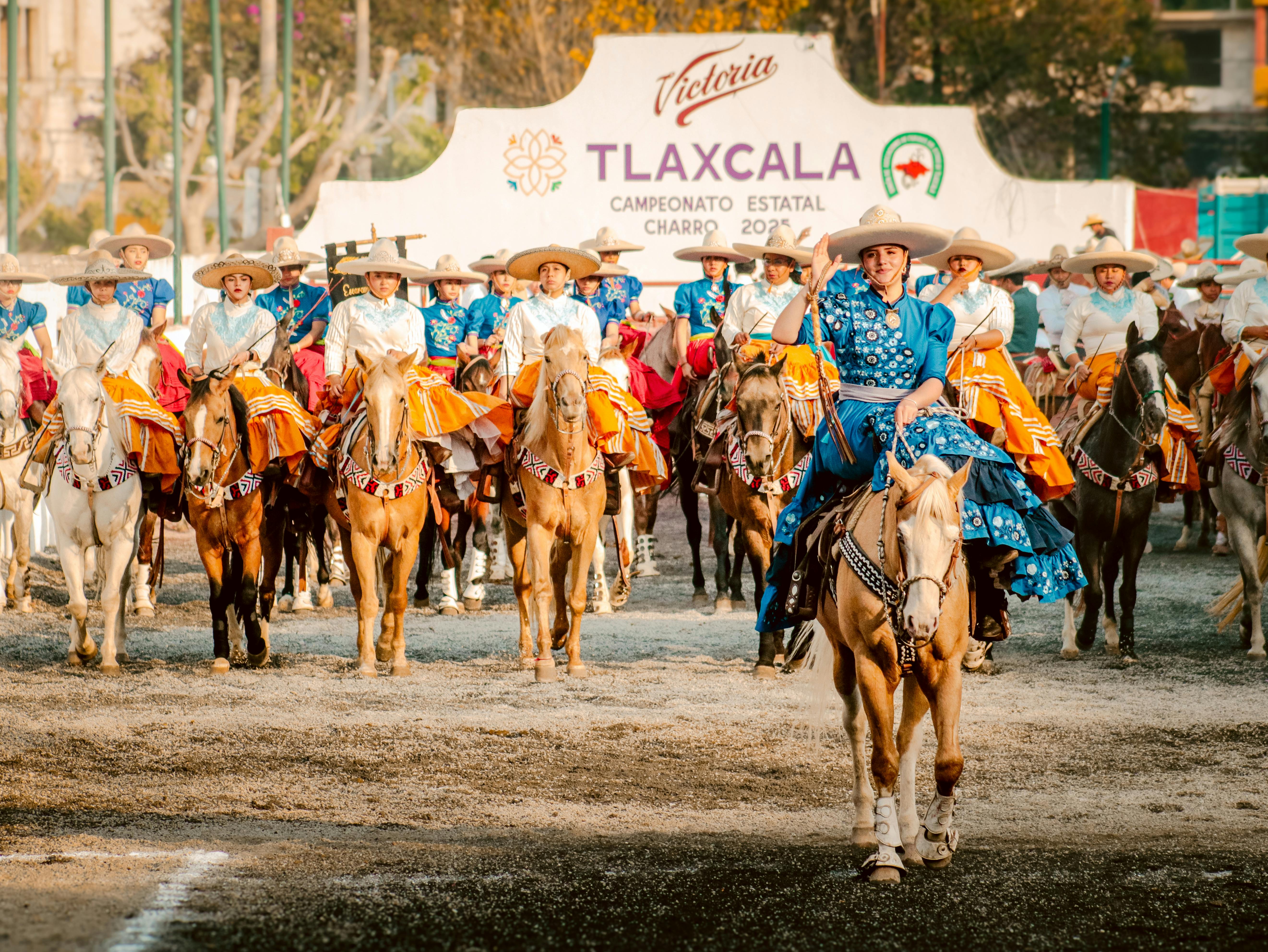 Vibrant charro riders in traditional attire at the Tlaxcala charro event, showcasing Mexican equestrian culture.