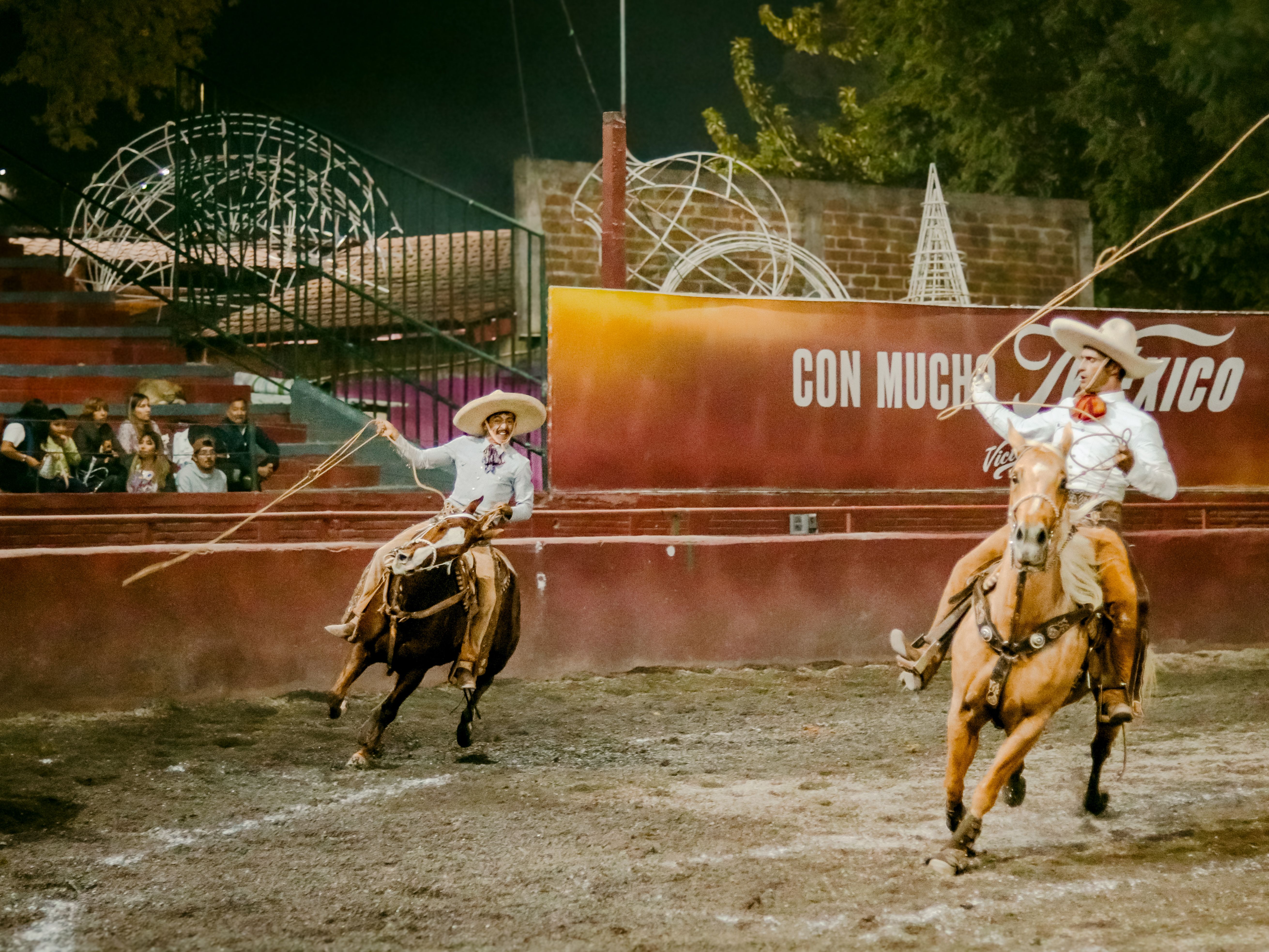 Mexican traditional festival arena prepared for a licensed event, empty wooden seating, officials reviewing documents