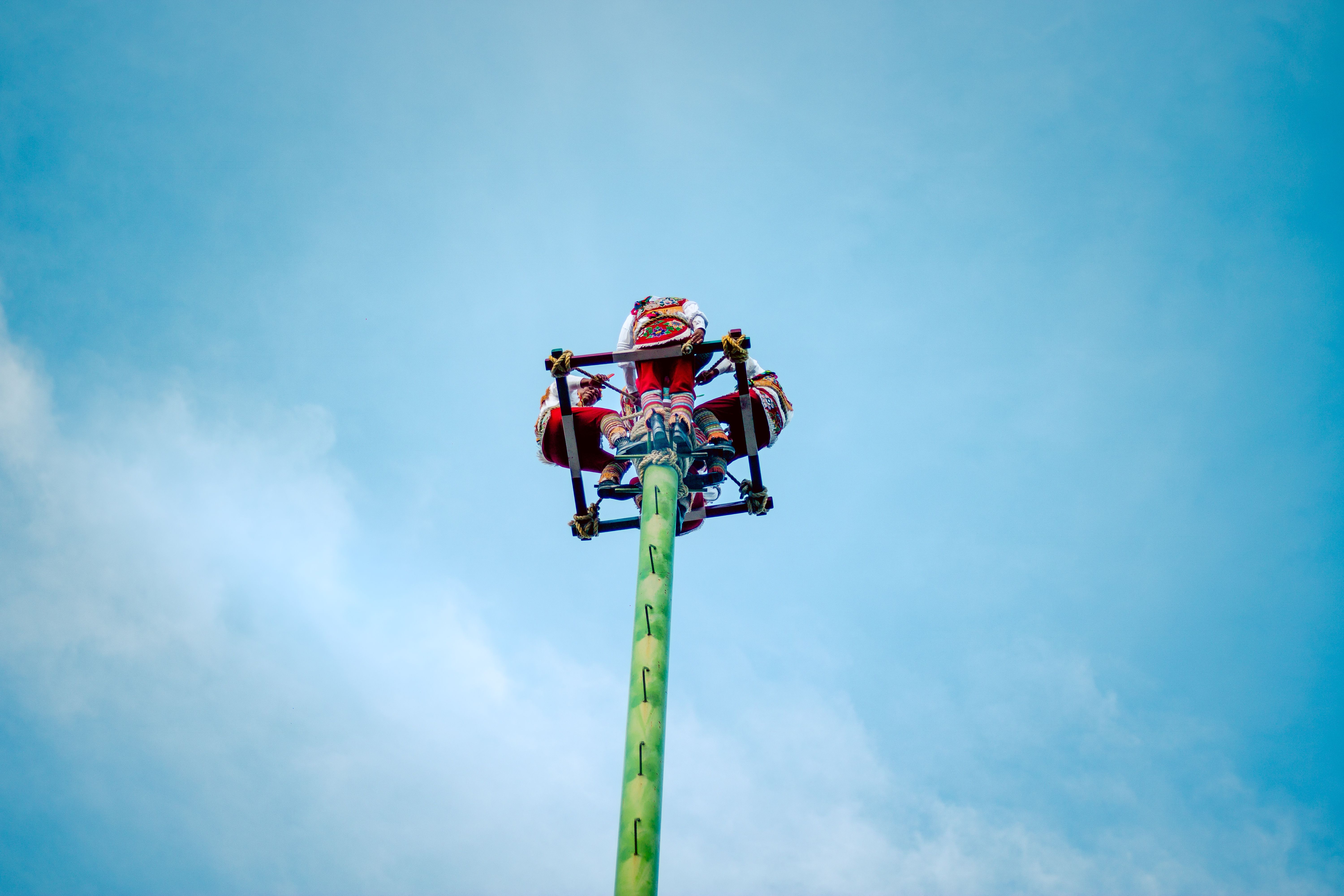 Thrilling High-Flying Carnival Ride Against Blue Sky · Free Stock Photo