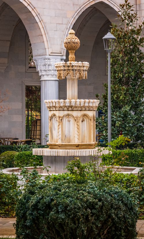 Free Beautiful ornate stone fountain in a historical courtyard garden setting. Stock Photo