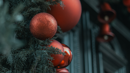 Free Close-up of red Christmas ornaments on evergreen branches, capturing winter festivity. Stock Photo