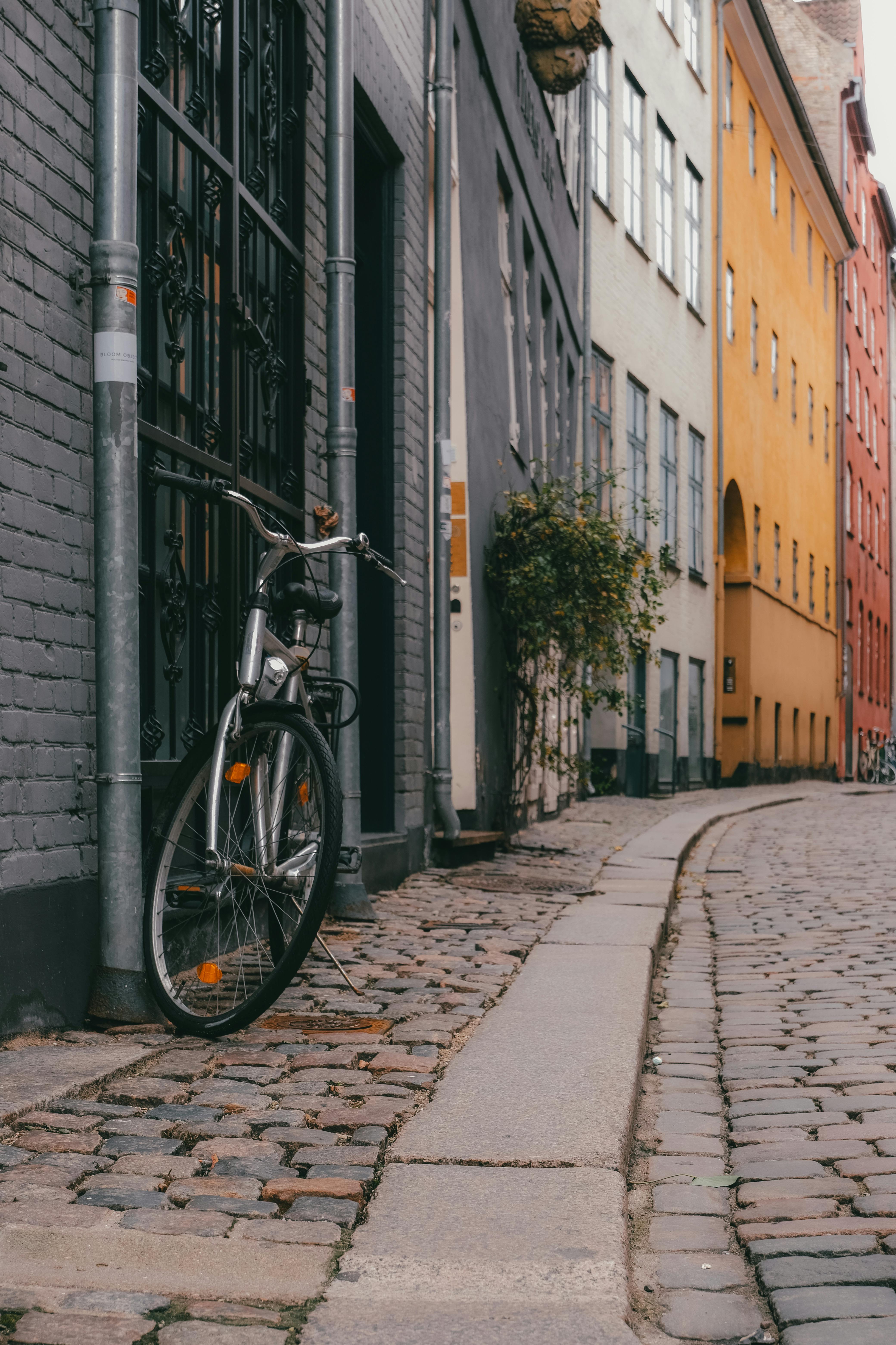 A picturesque street in Copenhagen featuring colorful buildings and a bicycle.