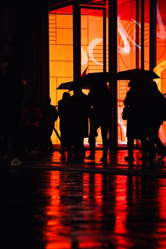 Silhouetted figures with umbrellas against a vivid backdrop by kadir alkn on Pexels
