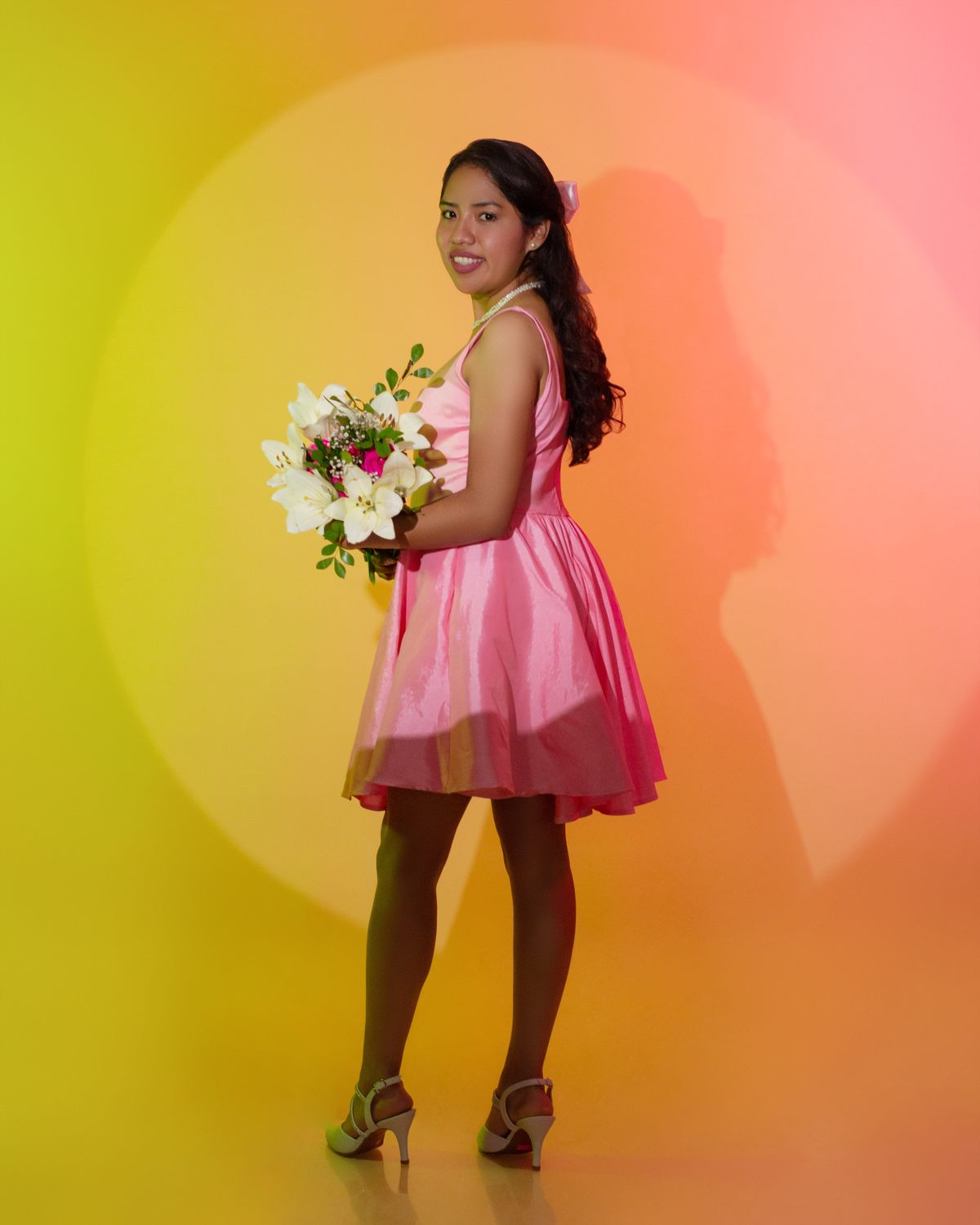 Elegant Young Woman Holding Bouquet in Pink Dress · Free Stock Photo