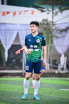 Young soccer player in action on a Hà Nội artificial turf field.