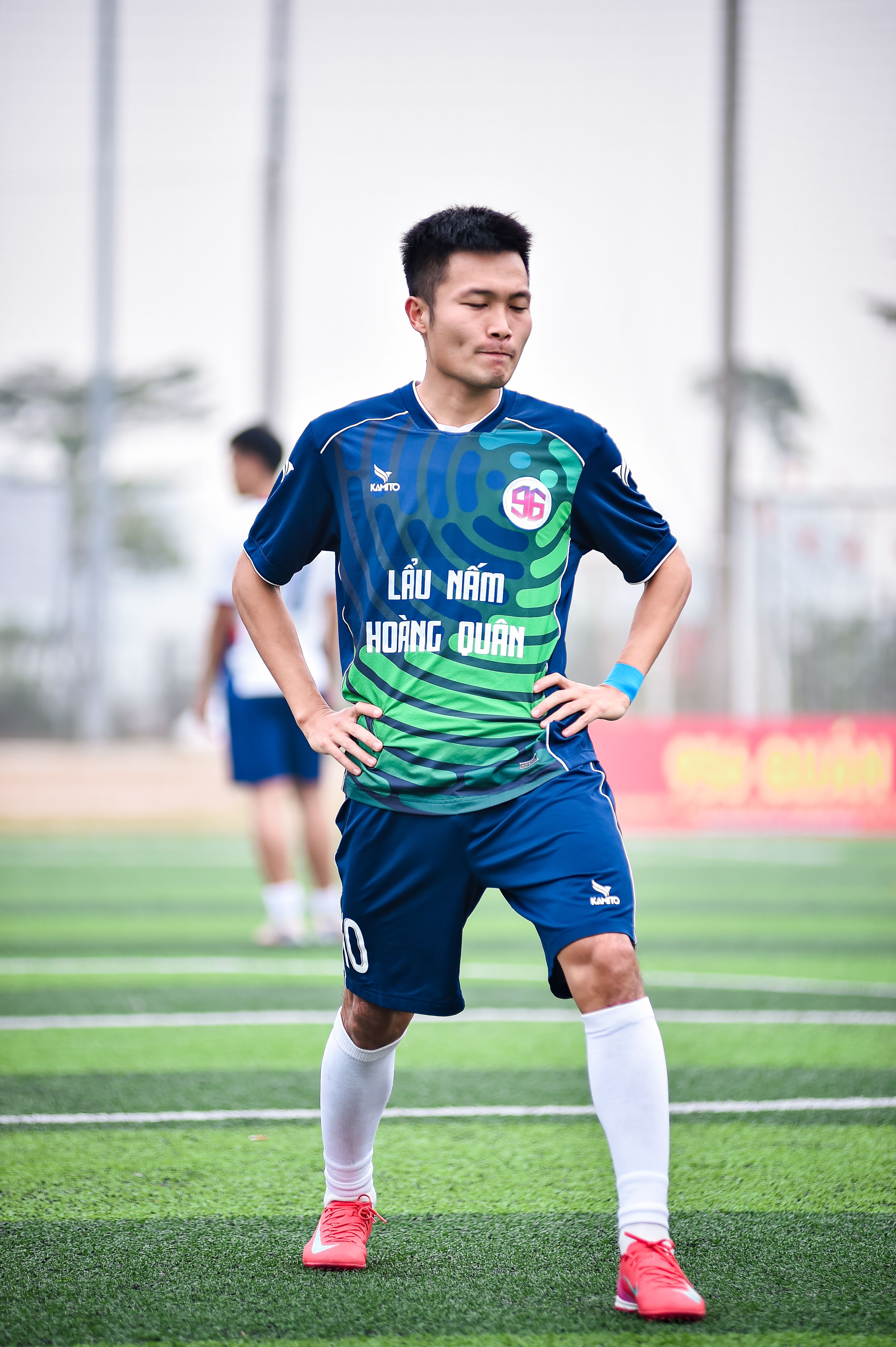 Portrait of a young male footballer on artificial turf in Hanoi, Vietnam, ready for the game.