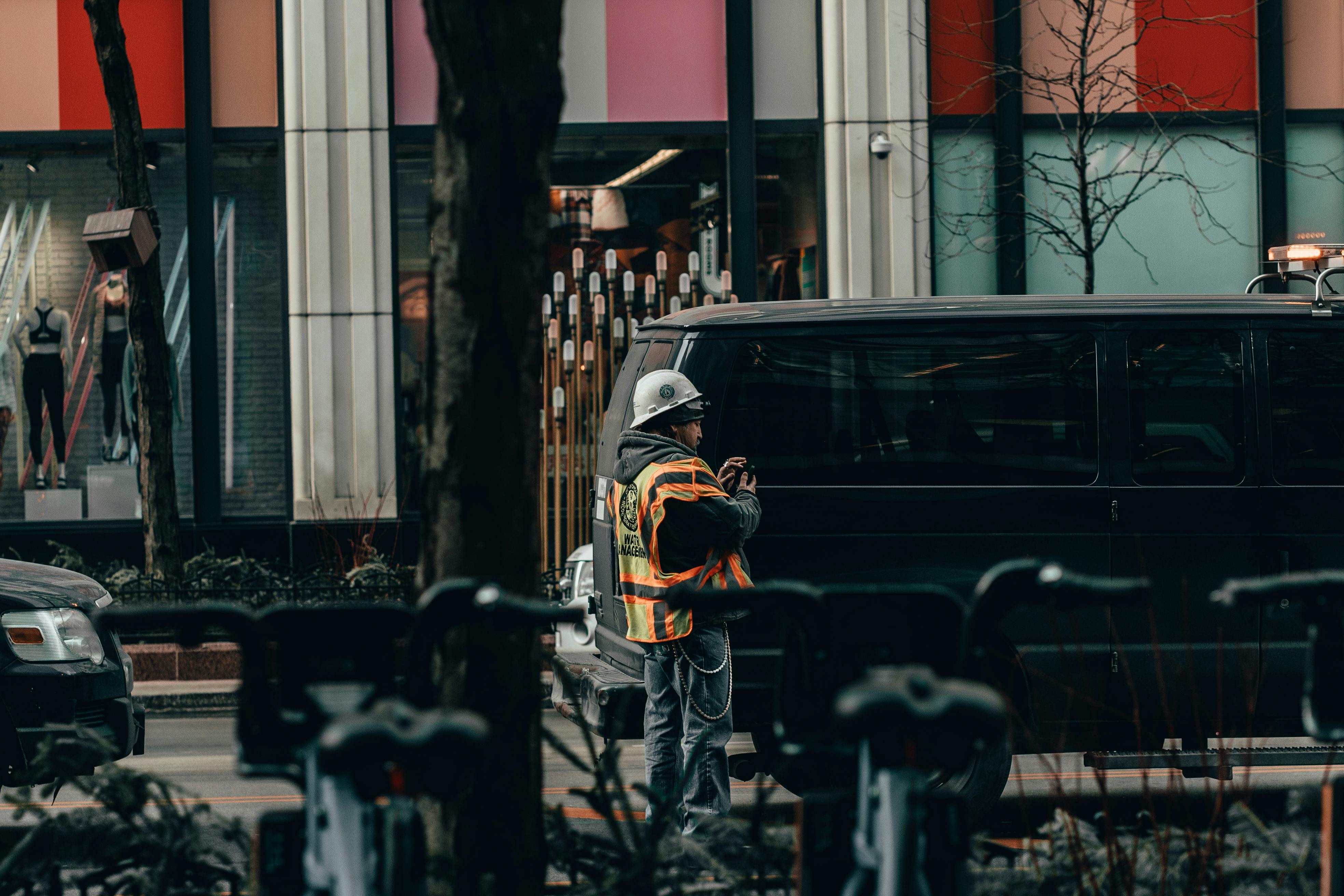 man standing beside black van