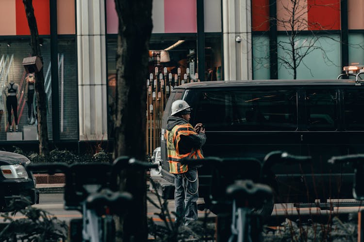 Man Standing Beside Black Van