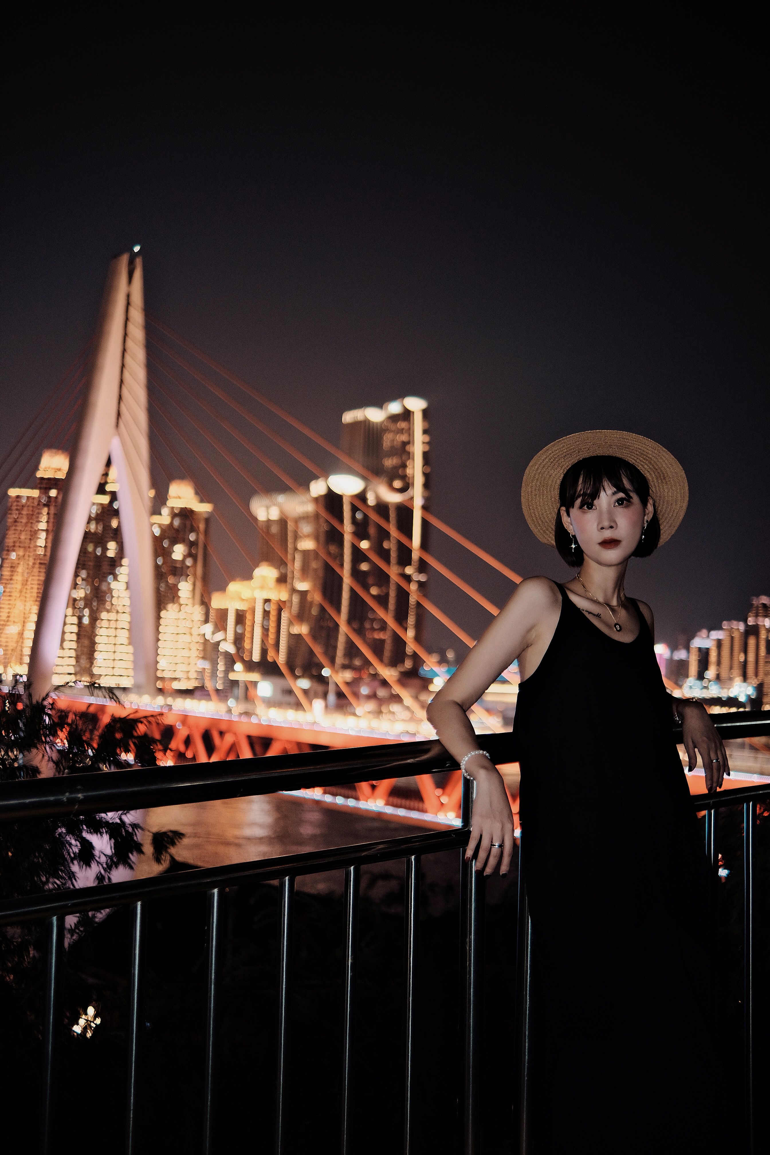 Stylish Woman Posing by City Bridge at Night · Free Stock Photo