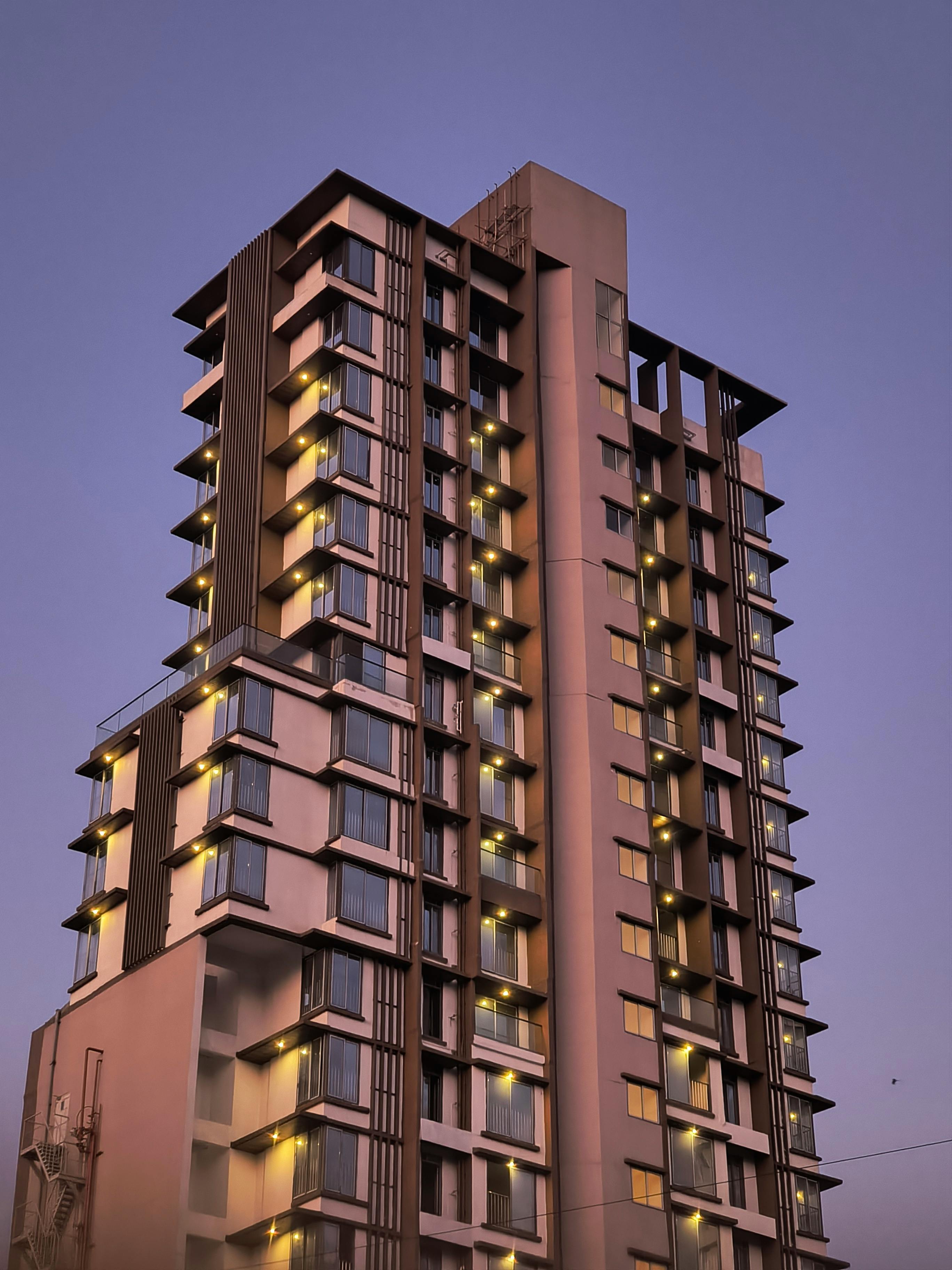 A modern high-rise building in Mumbai captured at twilight, showcasing urban architecture.
