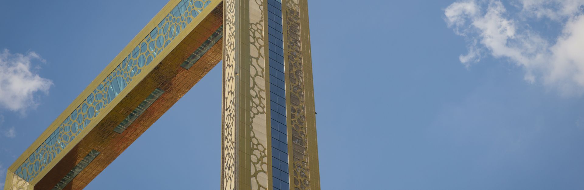The Dubai Frame soaring against a clear blue sky, showcasing modern design and architecture.