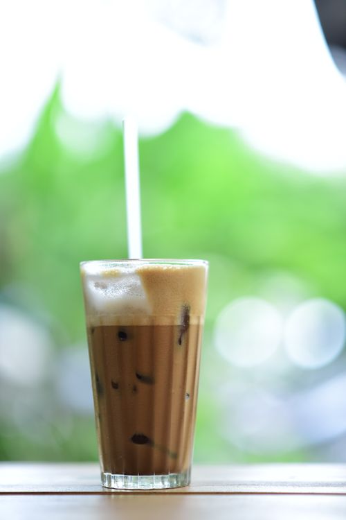 Free Chilled iced coffee in a tall glass with frothy top, perfect for a summer refreshment. Stock Photo