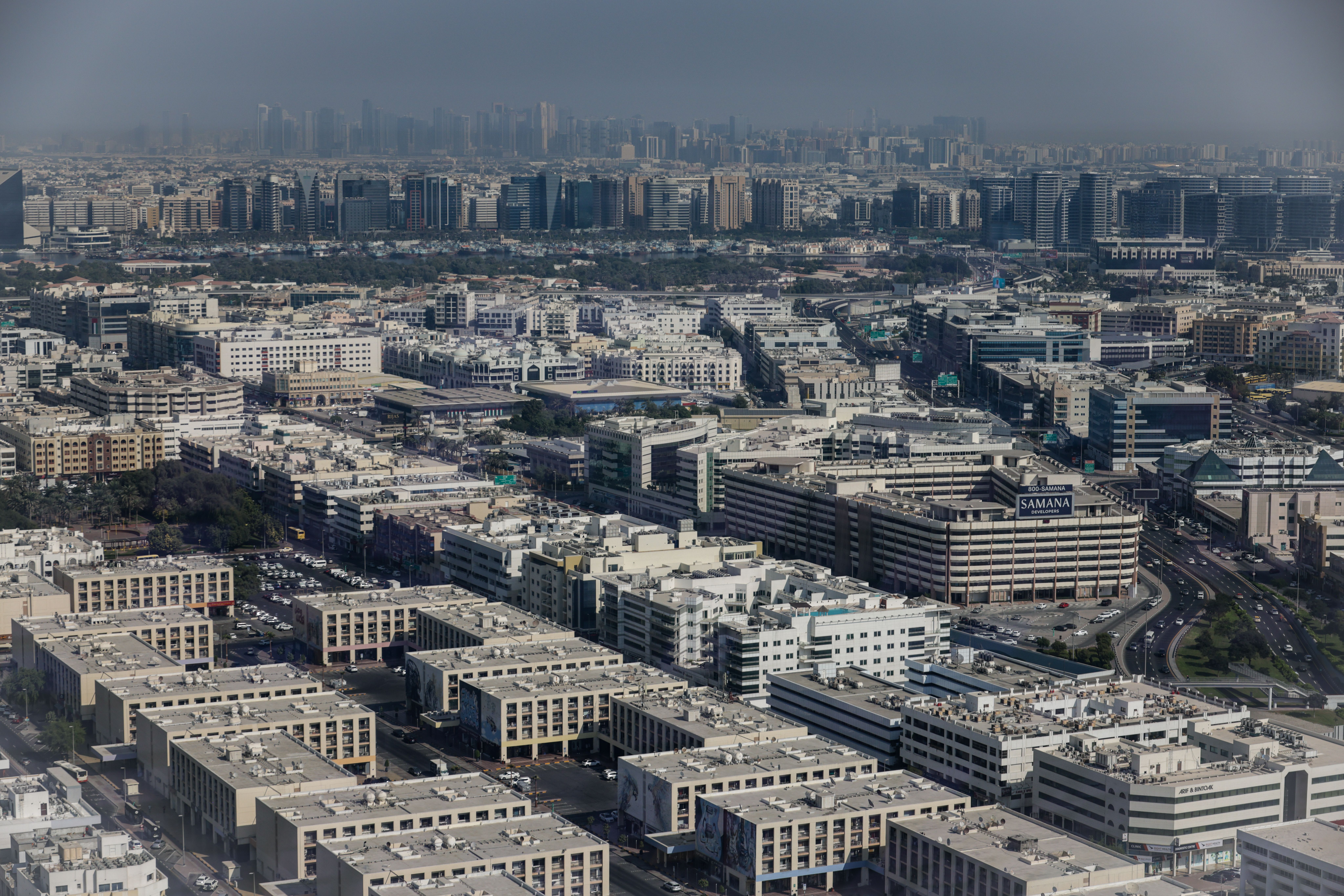 Aerial view showcasing the dense urban architecture of Dubai, featuring modern buildings and city li