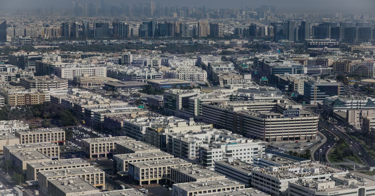 Aerial view showcasing the dense urban architecture of Dubai, featuring modern buildings and city li