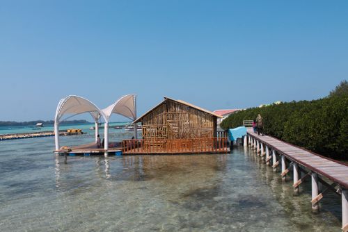 Free stock photo of bamboo house, blue sky, clear shallow water Stock Photo