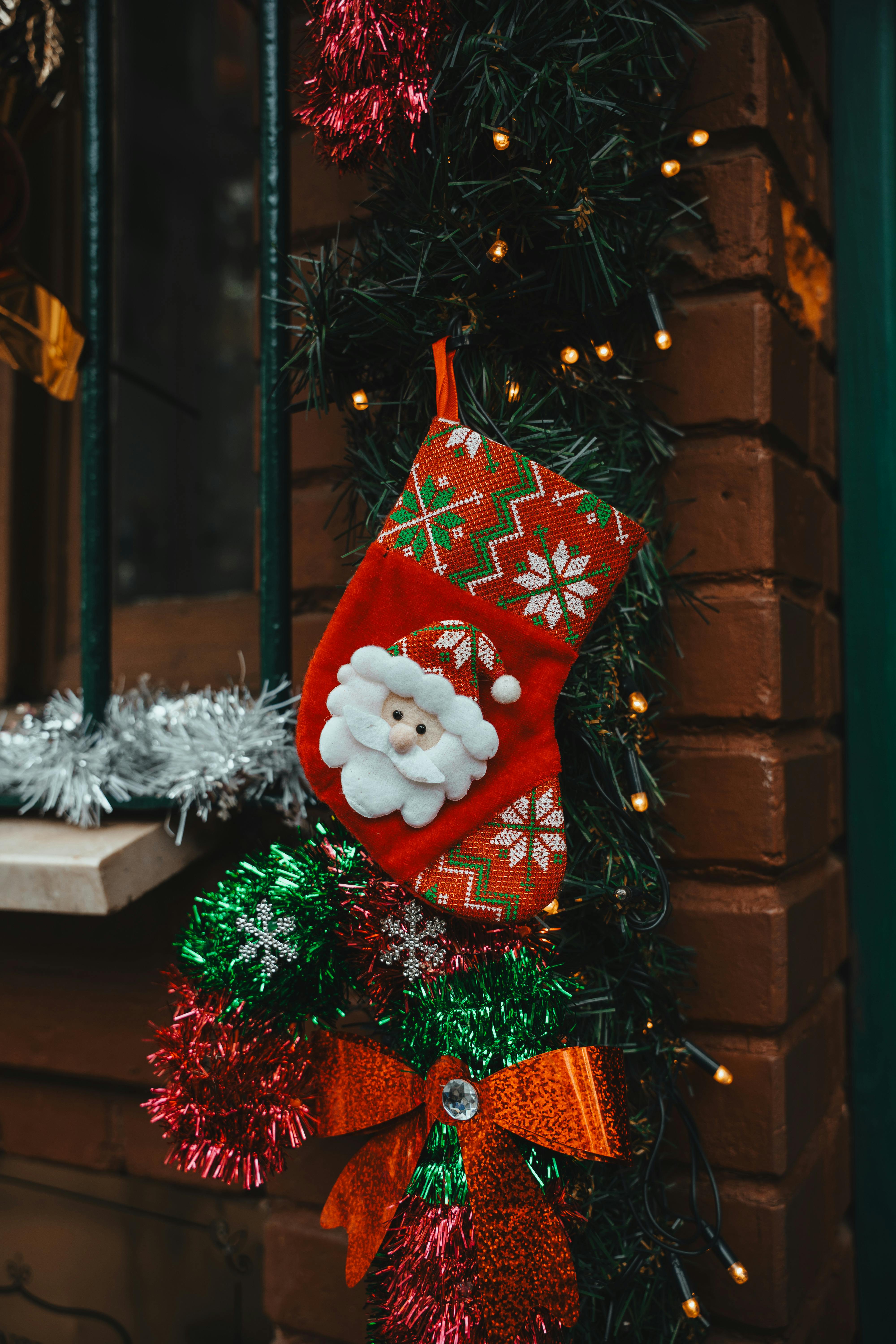 Vivid red Christmas stocking with Santa decoration on a brick wall in İstanbul, Türkiye.