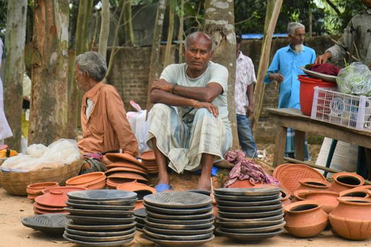 A serene village market in Rangpur showcasing traditional pottery and local vendors.