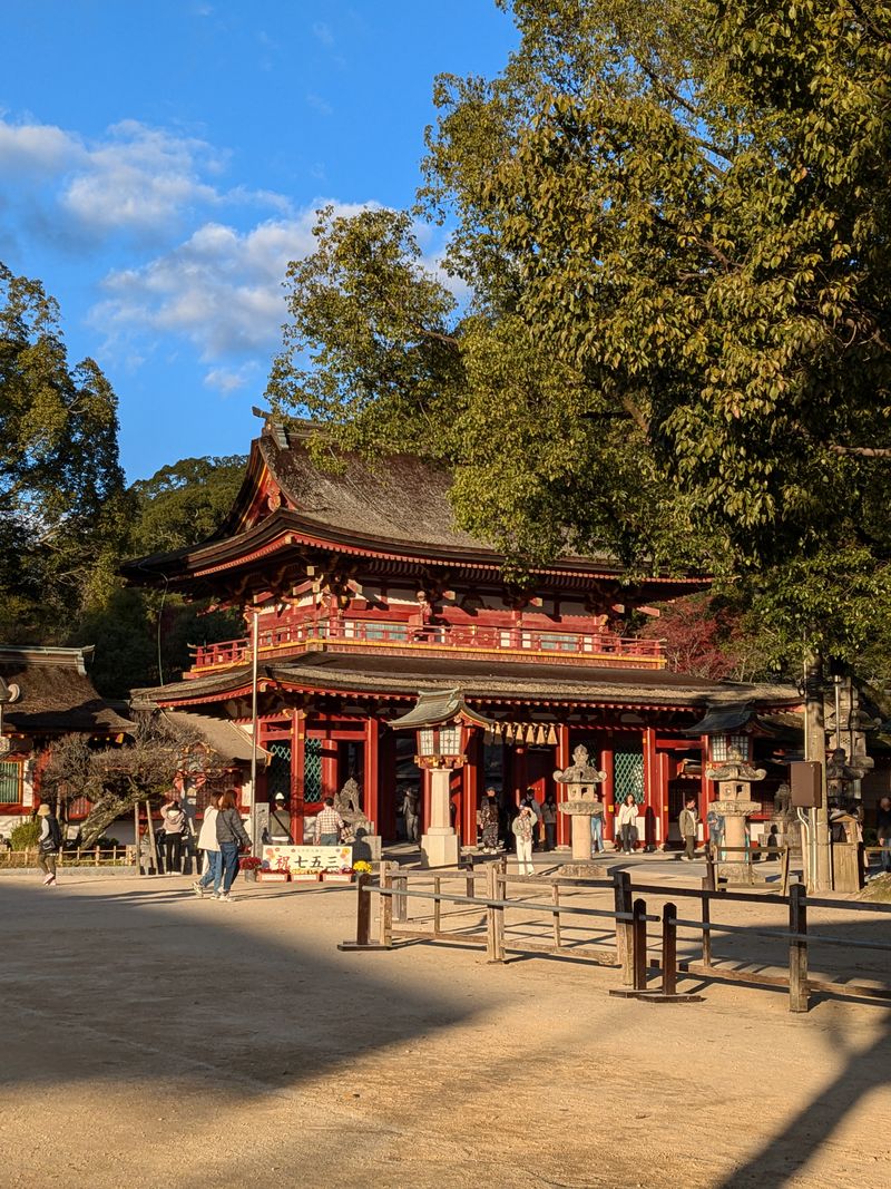 Red wooden romon gate and main hall of Dazaifu Tenmangu shrine in Fukuoka
