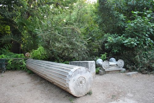 Free Column ruins in a verdant garden, depicting historical decay amidst natural beauty. Stock Photo