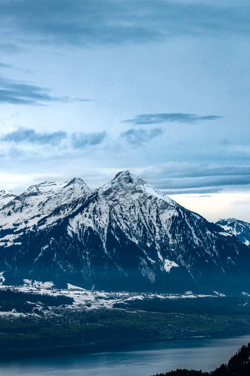 Free Breathtaking view of the snow-covered mountains in the Swiss Alps, showcasing nature's winter beauty. Stock Photo