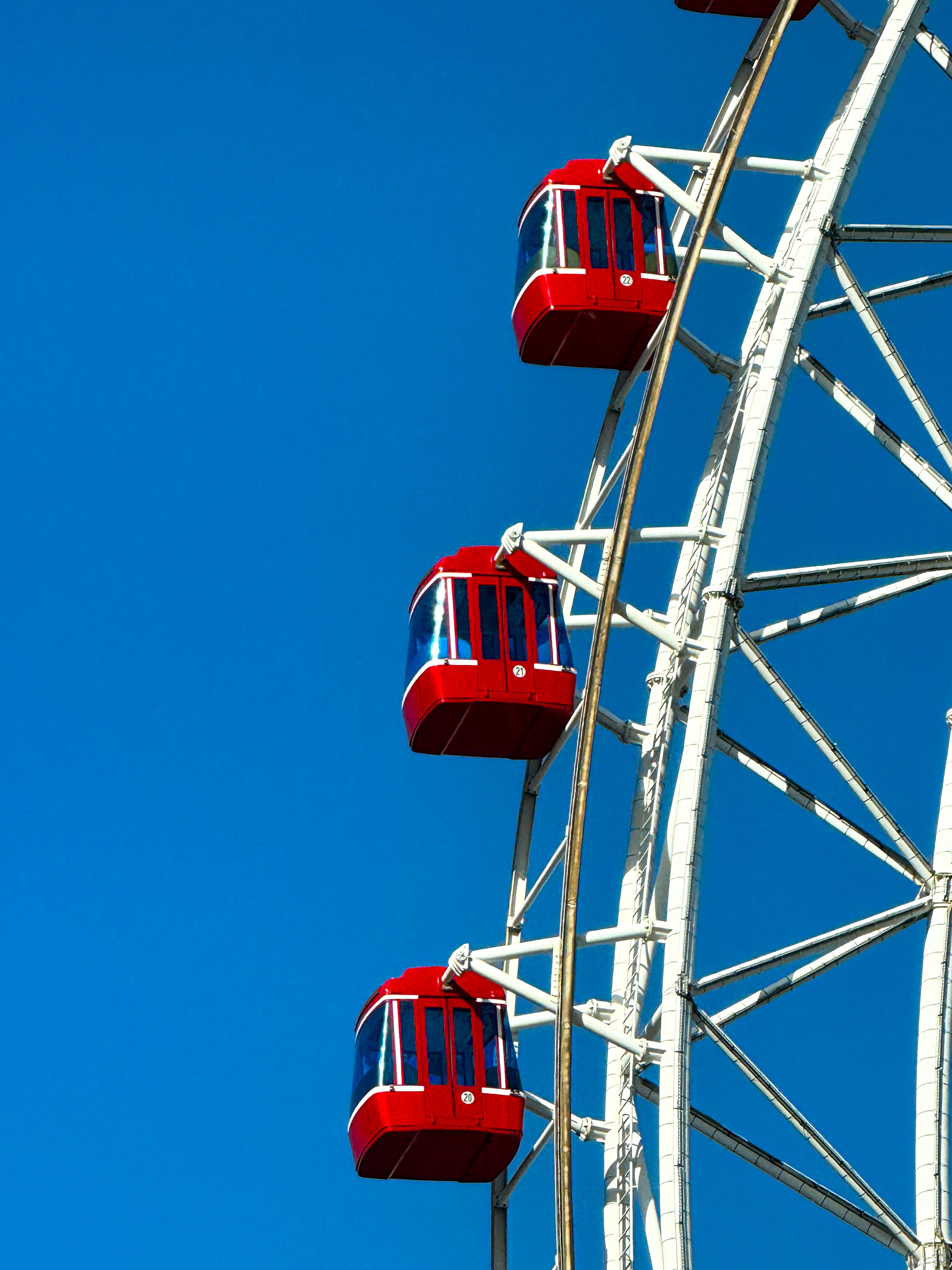 Bright Red Ferris Wheel Against Blue Sky · Free Stock Photo