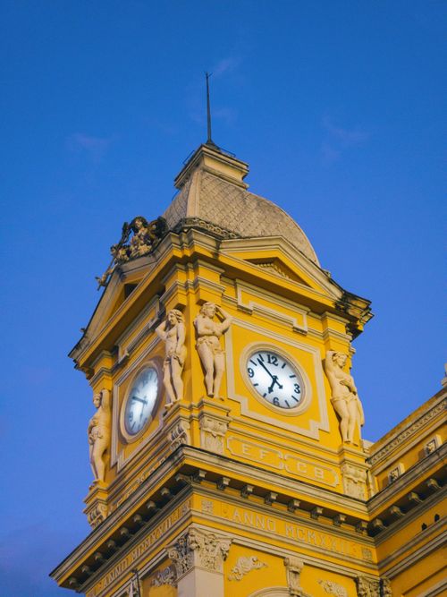 Free Historic yellow clock tower at Belo Horizonte station against a clear blue sky. Stock Photo
